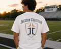 Jackson Christian Eagles crest logo on a cream vintage-wash cotton tee